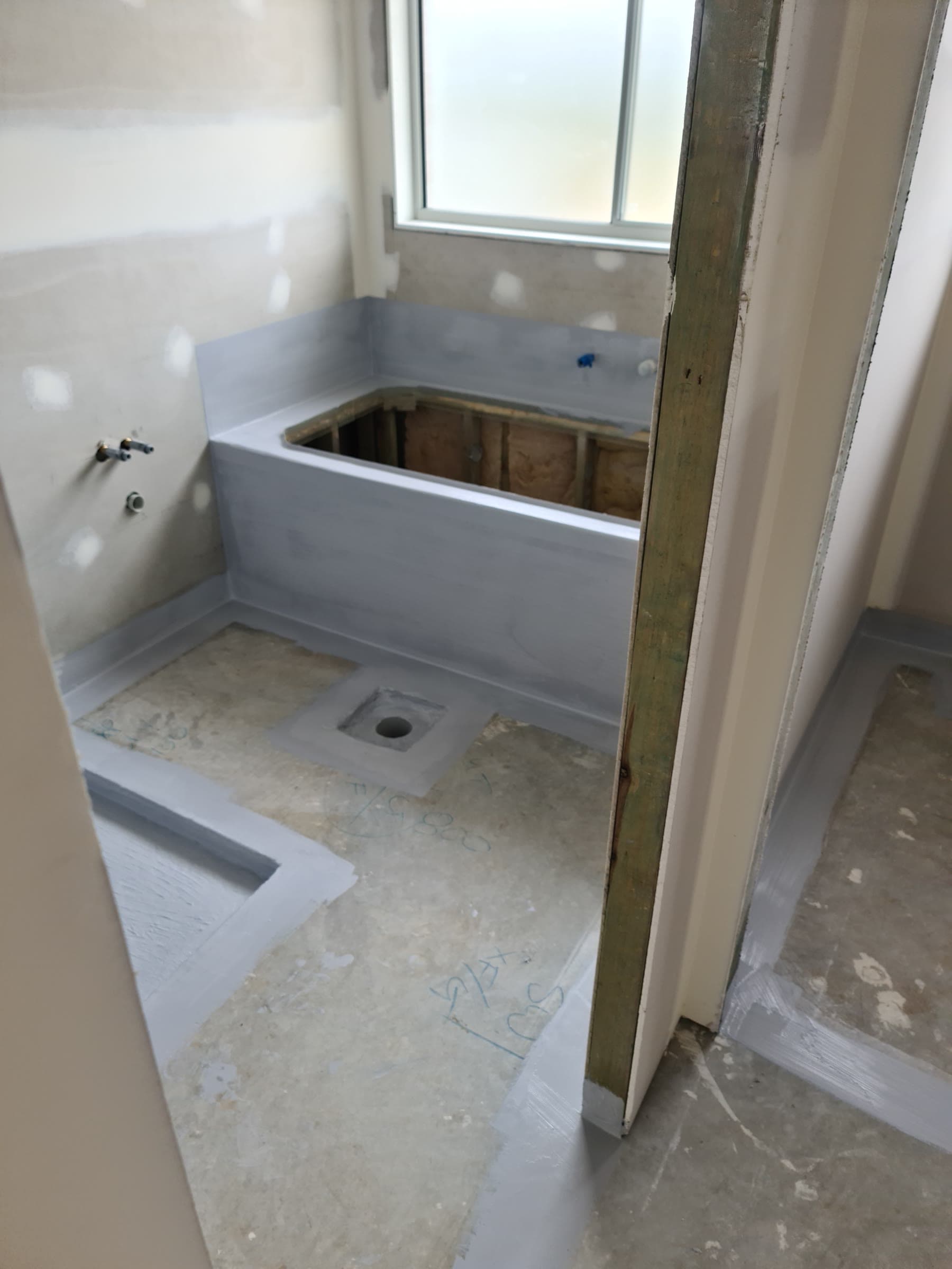 Bathtub surround and wet area floor mid waterproofing